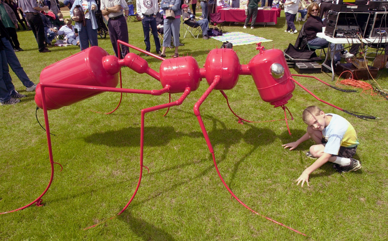 A boy plays near a fire ant sculpture at the seventh annual Fire Ant Festival March 23, 2002 in Ashburn, GA.